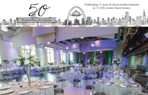 A beautifully decorated banquet hall set up for an event, with tables covered in gray linens, floral centerpieces, and elegant place settings. A banner above celebrates "50 Greatest Places to Entertain" with an illustrated city skyline.
