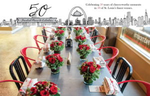 A dining table is elegantly set with bouquets of red roses in green vases, surrounded by red and black chairs. The top of the image features a city skyline illustration with text celebrating 50 years of venues in St. Louis.