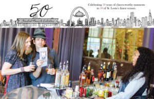 A woman and a man at a bar counter look at a flyer together, while a bartender in a blue shirt smiles at them. Various bottles and ingredients are visible on the counter. A banner above celebrates 50 years of entertainment in St. Louis venues.