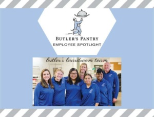 A group of seven smiling people wearing matching blue shirts stand together. The background has a logo with a figure holding a tray and the text "Butler's Pantry Employee Spotlight" and "butler's boardroom team." The border has diagonal stripes.