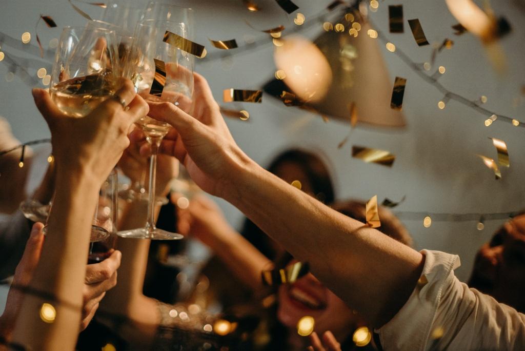 Corporate holiday party cheers with gold confetti 