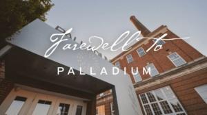 A building with a prominent chimney is shown against a clear sky. In the foreground, a sign reads "Farewell to Palladium" in elegant script. The angle captures both the structure and the message.